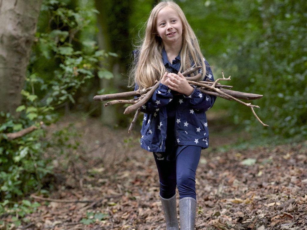 girl carrying branches