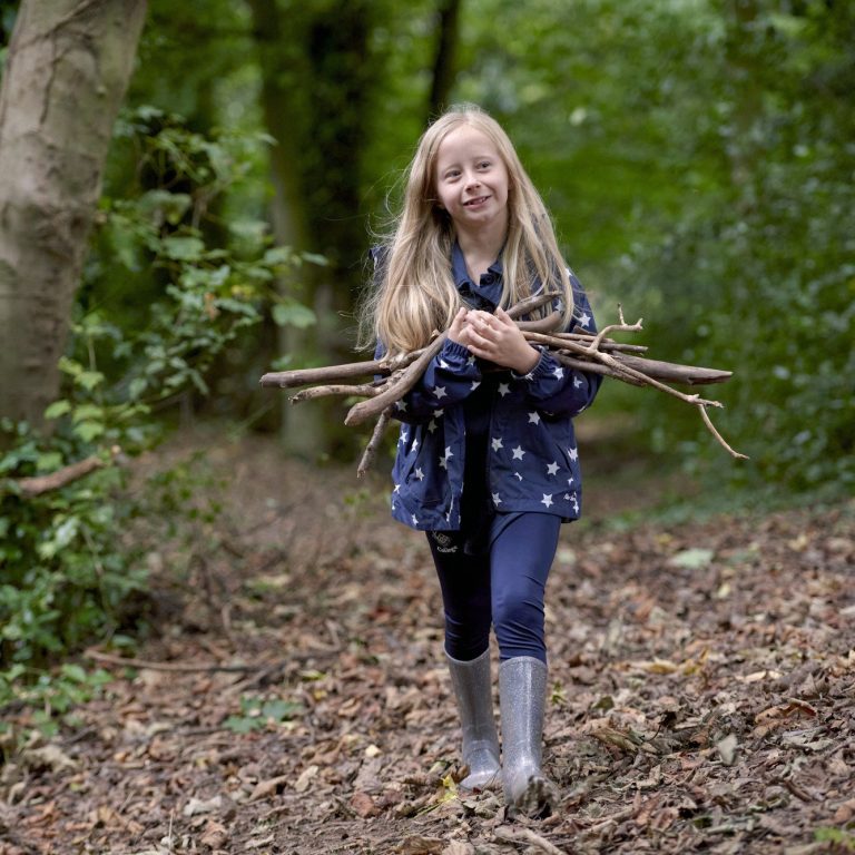 girl carrying branches