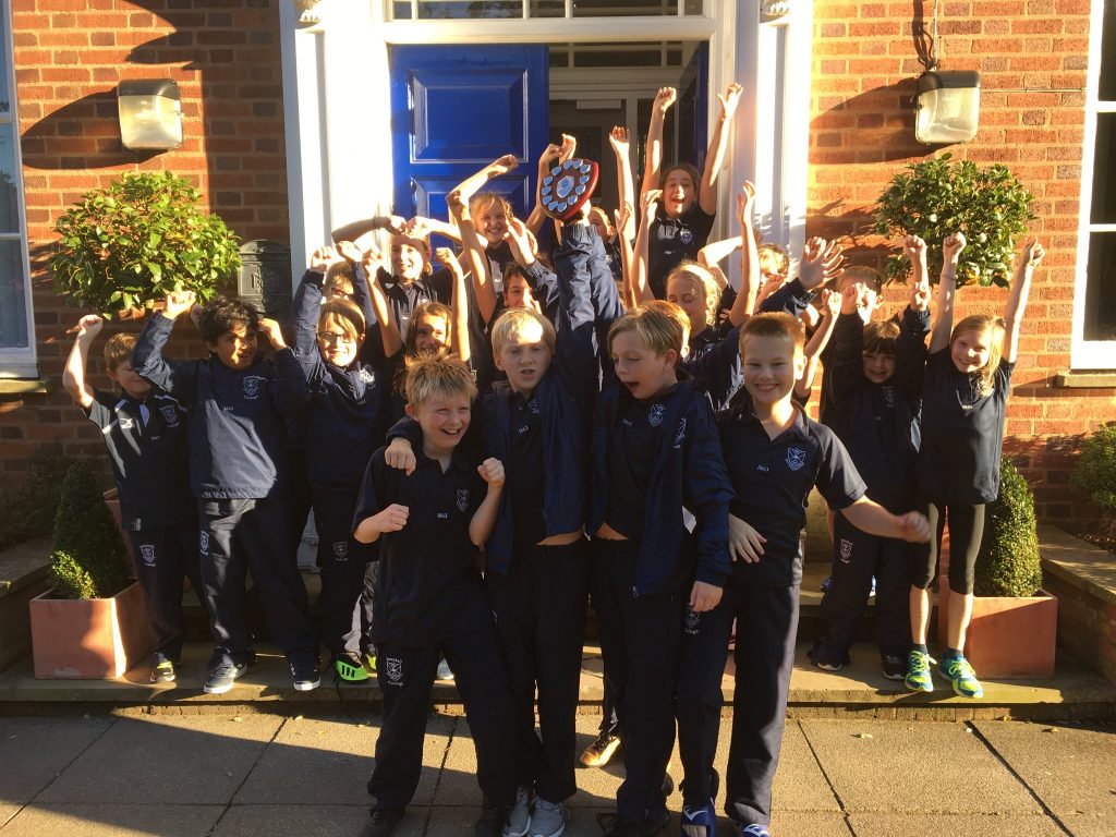 students cheering after winning a medal