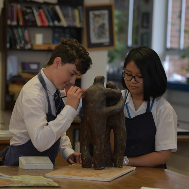 Students working together to make a sculpture