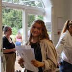 Smiling student with their results