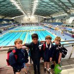 Students stood by a pool for a picture