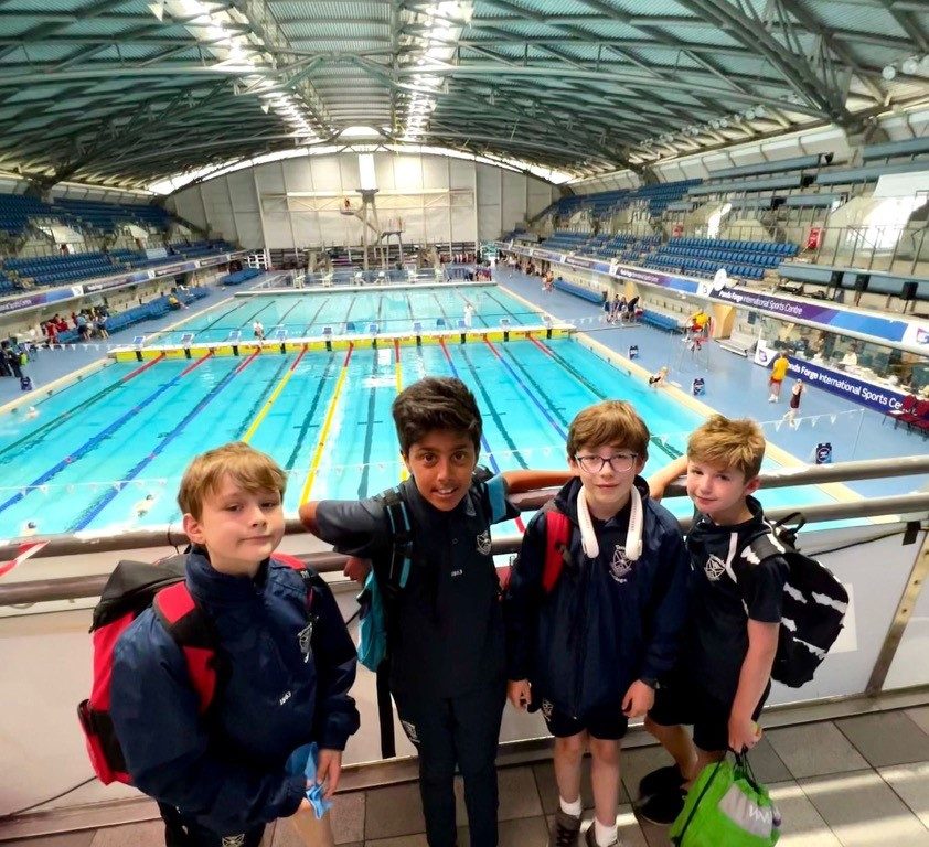 Students stood by a pool for a picture