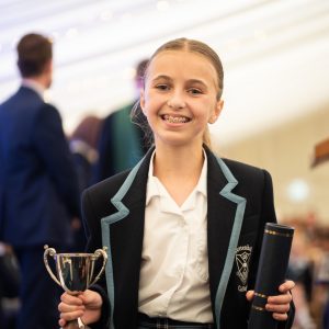 student holding a trophy