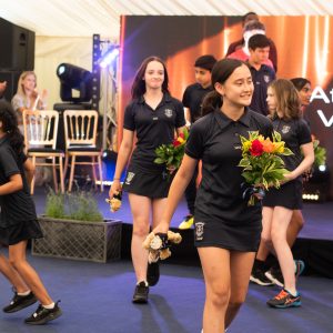 students holding flowers