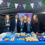 girls with cupcakes on the stall